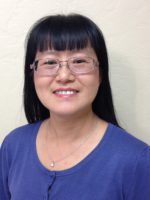 Portrait of Dr. Lo in blue blouse.