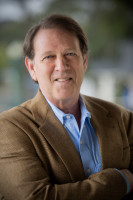 Dr. Eliot Light portrait in brown suit jacket and blue shirt.